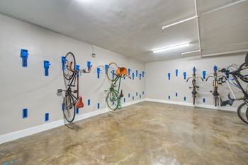 a room with several bikes hanging on the wall